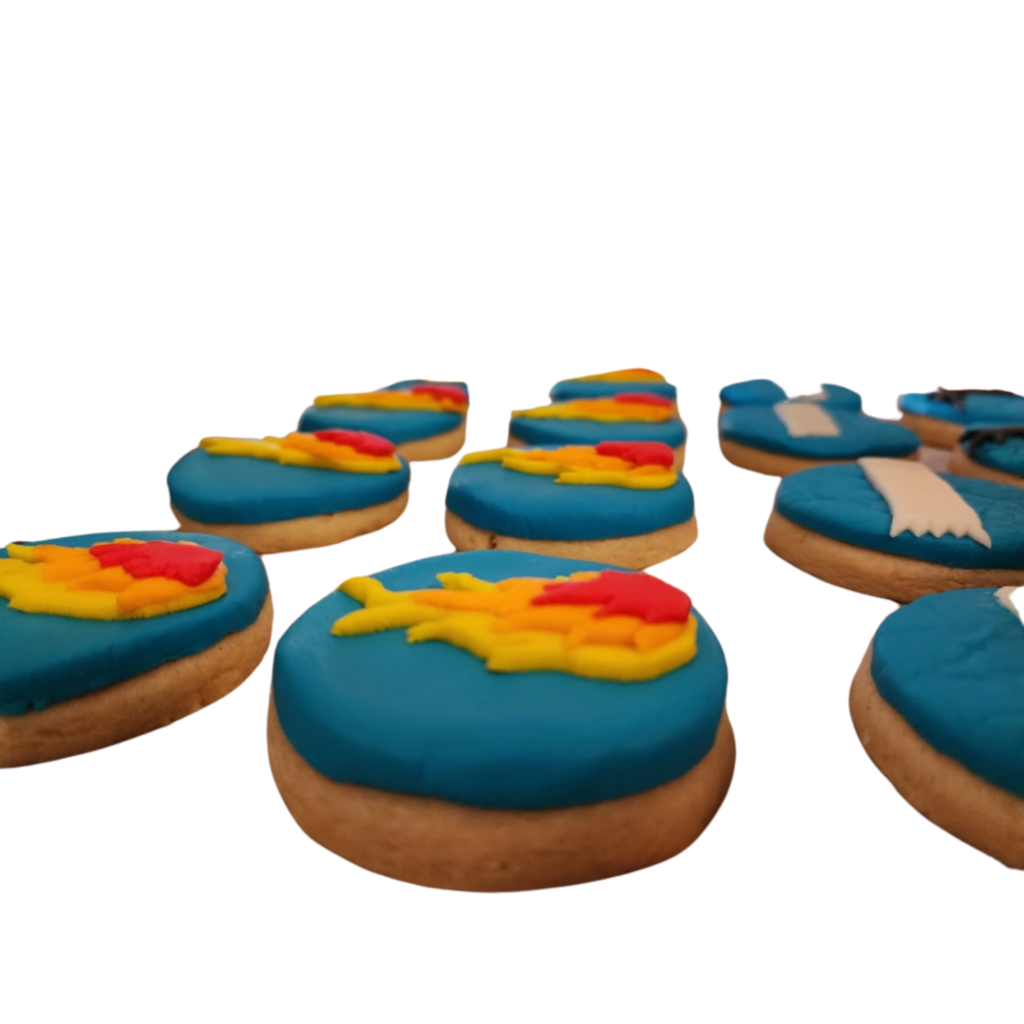 Custom-decorated round sugar cookies with bright blue, orange, and yellow rolled buttercream designs.