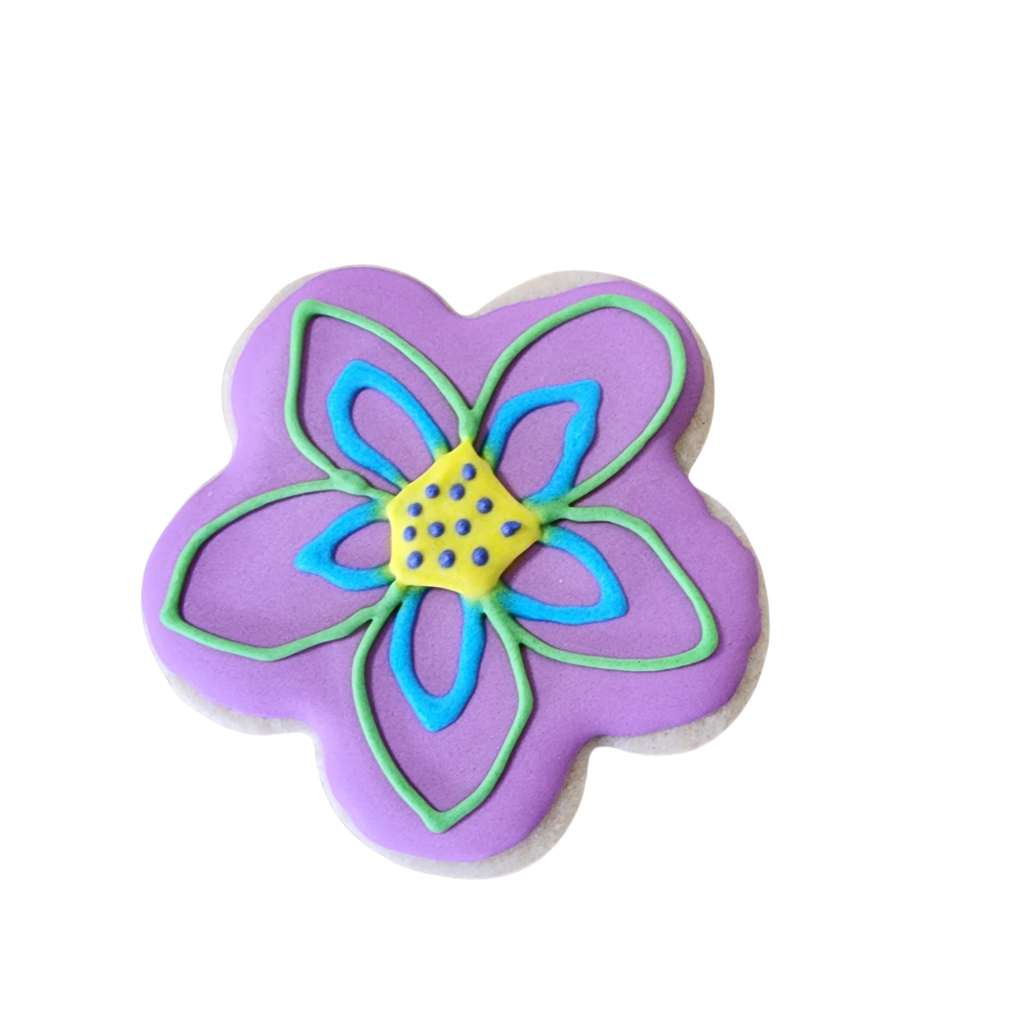 Hand-piped purple flower sugar cookie with intricate pink and yellow royal icing details.