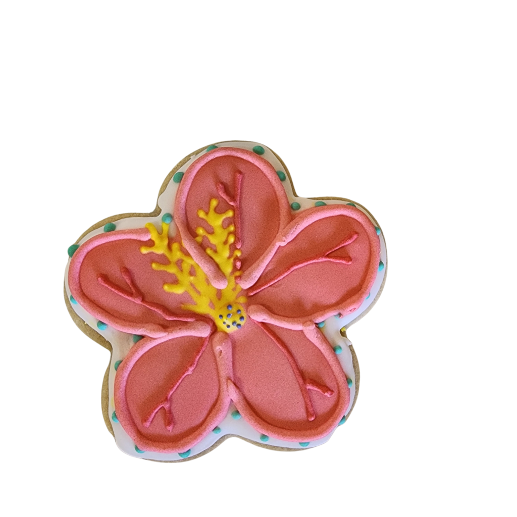 Hand-decorated coral pink flower sugar cookie with detailed yellow royal icing center.