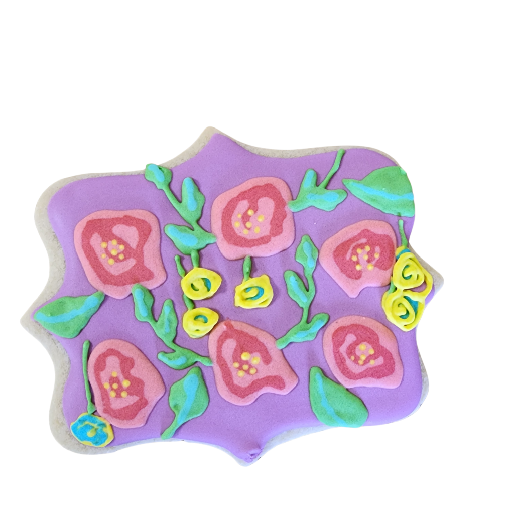 Hand-decorated plaque sugar cookie with vibrant pink and red royal icing roses and greenery.