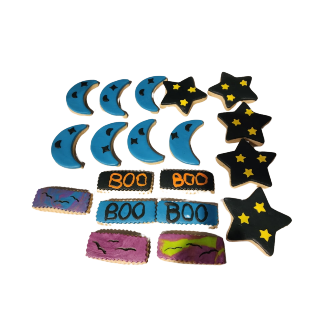 A celestial-themed sugar cookie set featuring crescent moons and stars with gold and blue royal icing.